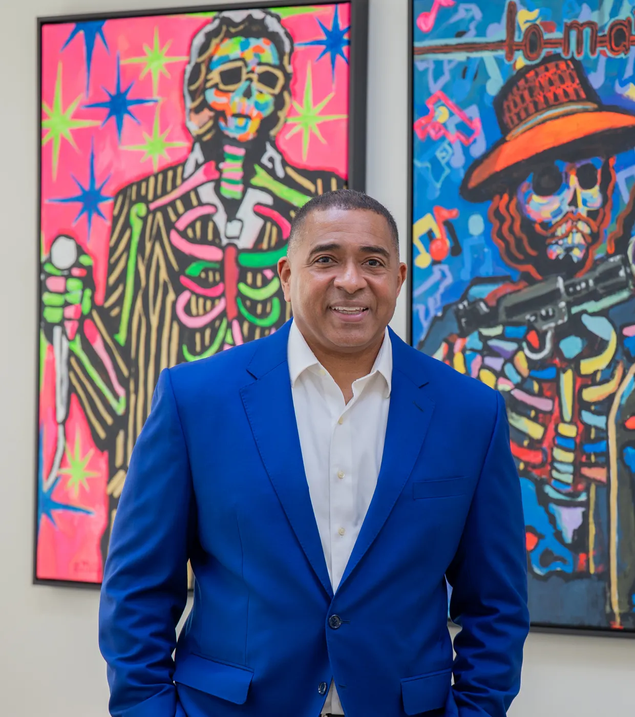 Michael Garcia, founding attorney, in front of colorful paintings